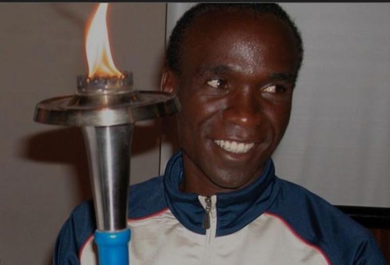 A 19-year-old Eliud Kipchoge holds the Sri Chinmoy Oneness-Home Peace Torch